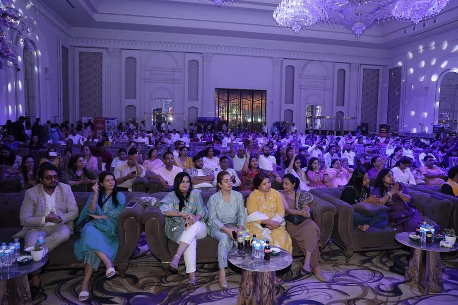 Guests gathered in a ballroom under purple event lighting